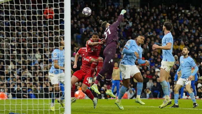 Manchester Citys goalkeeper Ederson, center, clears the ball during the Champions League quarterfinal, first leg, soccer match between Manchester City and Bayern Munich at the Etihad stadium in Manchester, England, Tuesday, April 11, 2023. (AP Photo/Jon Super)