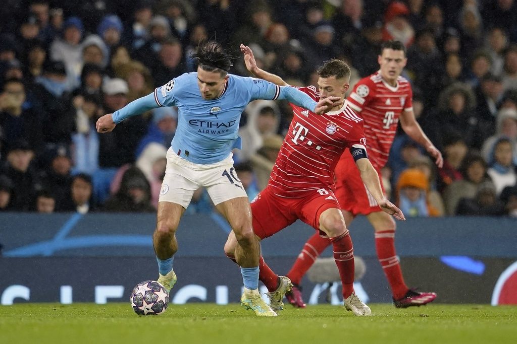 Bayern's Joshua Kimmich, right, tries to stop Manchester City's Jack Grealish during the Champions League quarterfinal, first leg, soccer match between Manchester City and Bayern Munich at the Etihad stadium in Manchester, England, Tuesday, April 11, 2023. (AP Photo/Dave Thompson)