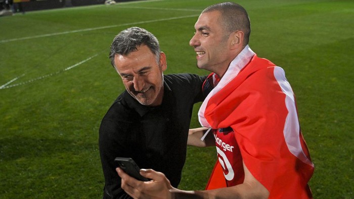 Lilles French head coach Christophe Galtier (L) and Lilles Turkish forward Burak Yilmaz celebrate after winning the French L1 football match between Angers SCO and Lille OSC at The Raymond-Kopa Stadium in Angers, north-western France on May 23, 2021. (Photo by LOIC VENANCE / AFP) (Photo by LOIC VENANCE/AFP via Getty Images)