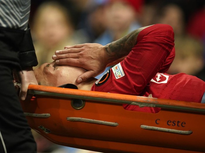 Manchester United's Lisandro Martinez is carried on stretcher after suffering an injury during the Europa League first leg quarterfinal soccer match between Manchester United and Sevilla at the Old Trafford stadium in Manchester, Thursday, April 13, 2023. (AP Photo/Dave Thompson)