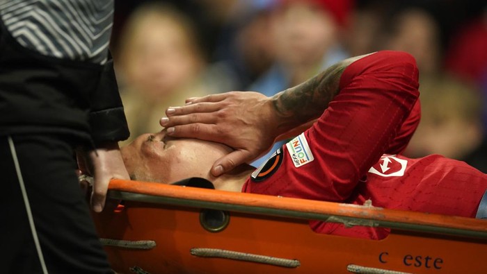 Manchester Uniteds Lisandro Martinez is carried on stretcher after suffering an injury during the Europa League first leg quarterfinal soccer match between Manchester United and Sevilla at the Old Trafford stadium in Manchester, Thursday, April 13, 2023. (AP Photo/Dave Thompson)