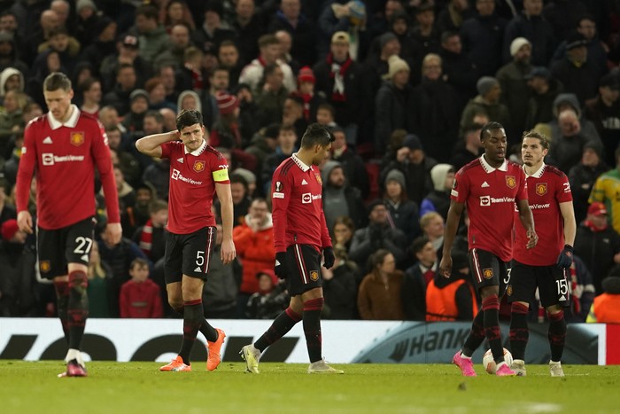Manchester Uniteds Harry Maguire, 2nd left, and his teammates react after getting scored on during the Europa League first leg quarterfinal soccer match between Manchester United and Sevilla at the Old Trafford stadium in Manchester, Thursday, April 13, 2023. (AP Photo/Dave Thompson)