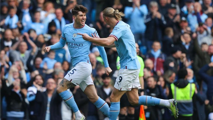 MANCHESTER, ENGLAND - APRIL 15: John Stones of Manchester City celebrates with Erling Haaland of Manchester City after scoring his sides first goal during the Premier League match between Manchester City and Leicester City at Etihad Stadium on April 15, 2023 in Manchester, England. (Photo by James Gill - Danehouse/Getty Images)