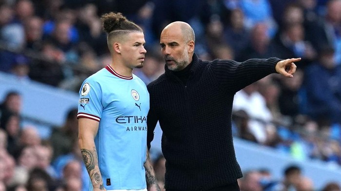 Manchester City manager Pep Guardiola (right) speaks to Kalvin Phillips ahead of being substituted on during the Premier League match at the Etihad Stadium, Manchester. Picture date: Saturday April 15, 2023. (Photo by Nick Potts/PA Images via Getty Images)