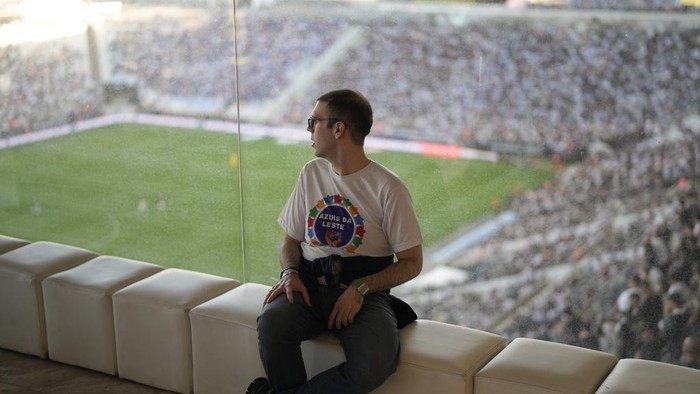 An autism spectrum disorder watches a Brazilian soccer championship match between Corinthians and Cruzeiro in a special isolated room where noise impacts less, at the Neo Quimica Arena in Sao Paulo, Brazil, Sunday, April 16, 2023. Brazilian soccer clubs are increasingly opening spaces for autistic fans to watch matches, mingle and celebrate the sport, an initiative that got even higher attention in April, when Autism Speaks celebrates World Autism Awareness Month. (AP Photo/Andre Penner)