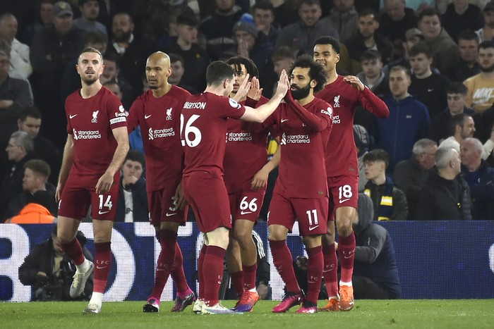 Liverpool players celebrate after Liverpool's Mohamed Salah, second right, scored his side's fourth goal during the English Premier League soccer match between Leeds United and Liverpool at Elland Road in Leeds, England, Monday, April 17, 2023. (AP Photo/Rui Vieira)