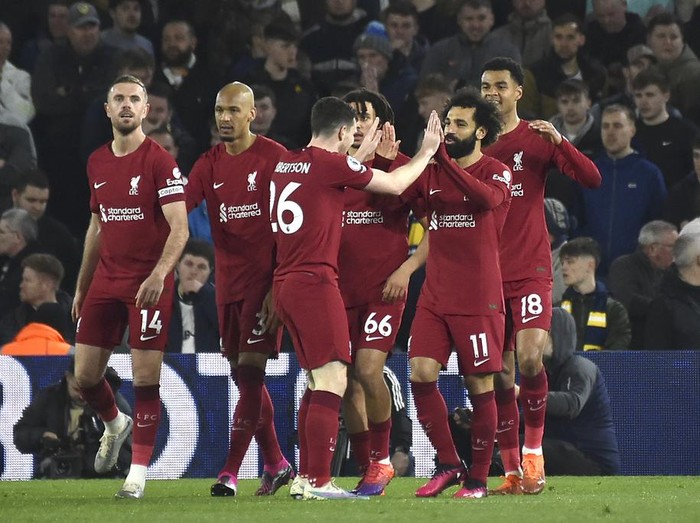 Liverpool players celebrate after Liverpool's Mohamed Salah, second right, scored his side's fourth goal during the English Premier League soccer match between Leeds United and Liverpool at Elland Road in Leeds, England, Monday, April 17, 2023. (AP Photo/Rui Vieira)