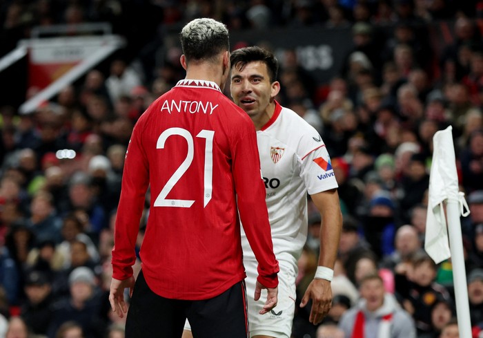 Soccer Football - Europa League - Quarter Final - First Leg - Manchester United v Sevilla - Old Trafford, Manchester, Britain - April 13, 2023  Manchester Uniteds Antony clashes with Sevillas Marcos Acuna Action Images via Reuters/Lee Smith