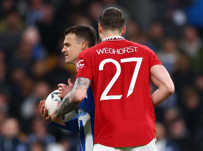 LONDON, ENGLAND - APRIL 23: Solly March of Brighton and Hove Albion is handed the ball by Wout Weghorst of Manchester United befire missing his penalty in the shootout during the Emirates FA Cup Semi Final match between Brighton & Hove Albion and Manchester United at Wembley Stadium on April 23, 2023 in London, England. (Photo by Marc Atkins/Getty Images)