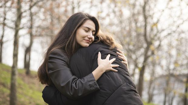 Two best friends hug for support.