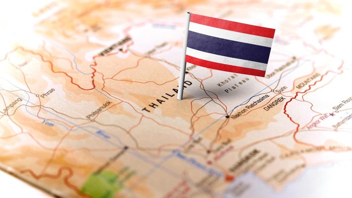 The flag of Thailand pinned on the map. Horizontal orientation. Macro photography.