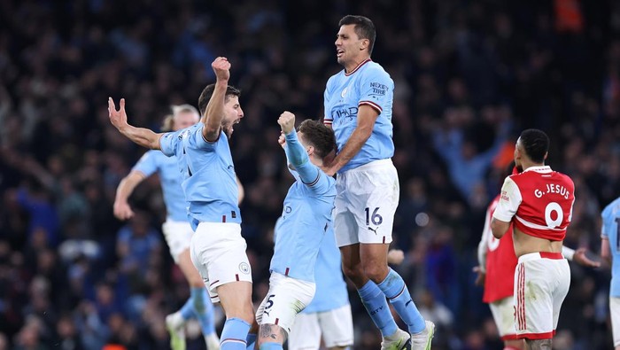 MANCHESTER, ENGLAND - APRIL 26: John Stones of Manchester City celebrates with Ruben Dias and Rodri after scoring their second goal during the Premier League match between Manchester City and Arsenal FC at Etihad Stadium on April 26, 2023 in Manchester, England. (Photo by Alex Livesey - Danehouse/Getty Images)