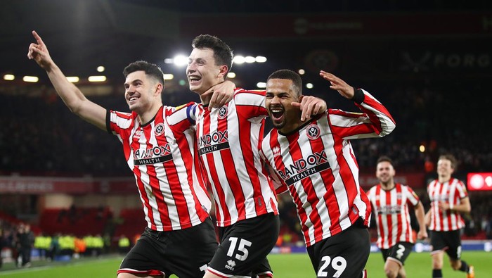 SHEFFIELD, ENGLAND - APRIL 26: Anel Ahmedhodzic (C) of Sheffield United celebrates with teammates John Egan (L) and Iliman Ndiaye (R) after scoring the teams second goal during the Sky Bet Championship between Sheffield United and West Bromwich Albion at Bramall Lane on April 26, 2023 in Sheffield, England. (Photo by George Wood/Getty Images)