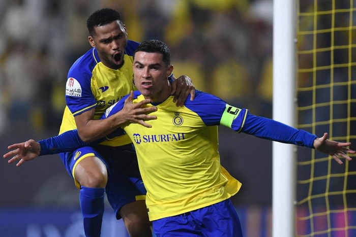 Al Nassr vs Al Raed Nassr's Portuguese forward Cristiano Ronaldo (R) celebrates scoring his team's first goal during the Saudi Pro League football match between Al-Nassr and Al-Raed at the al-Awwal Park Stadium in the Saudi capital Riyadh on April 28, 2023. (Photo by AFP) (Photo by -/AFP via Getty Images)