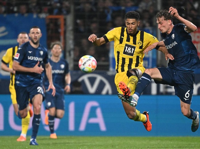 28 April 2023, North Rhine-Westphalia, Bochum: Soccer: Bundesliga, VfL Bochum - Borussia Dortmund, Matchday 30 at Vonovia Ruhrstadion, Bochums Patrick Osterhage and Dortmunds Jude Bellingham (l) in action. IMPORTANT NOTE: In accordance with the regulations of the DFL Deutsche Fußball Liga and the DFB Deutscher Fußball-Bund, it is prohibited to use or have used photographs taken in the stadium and/or of the match in the form of sequence pictures and/or video-like photo series. Photo: Federico Gambarini/dpa (Photo by Federico Gambarini/picture alliance via Getty Images)