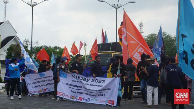 Massa di Yogyakarta mengibarkan bendera Partai Buruh saat menggelar unjuk rasa memperingati May Day, Senin (1/5).