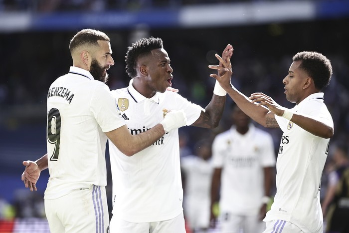 Real Madrids Karim Benzema, left, celebrates with his teammates Vinicius Junior and Real Madrids Rodrygo, right, after scoring his sides third goal during a Spanish La Liga soccer match between Real Madrid and Valladolid at the Santiago Bernabeu stadium in Madrid, Spain, Sunday, April 2, 2023. (AP Photo/Pablo Garcia)