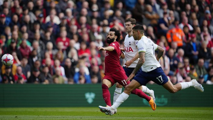 Liverpools Mohamed Salah, left tis chased by Tottenhams Cristian Romero during an English Premier League soccer match between Liverpool and Tottenham Hotspur at Anfield stadium in Liverpool, Sunday, April 30, 2023. (AP Photo/Jon Super)