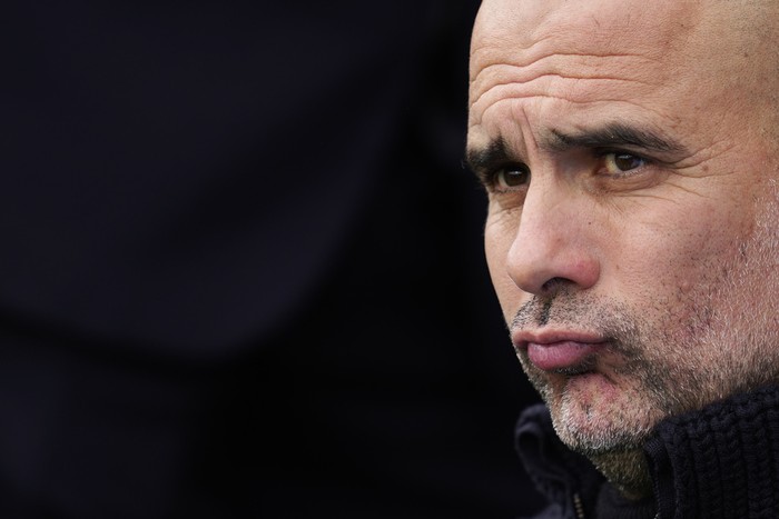 Manchester Citys head coach Pep Guardiola watches his players just before the start of the English Premier League soccer match between Fulham and Manchester City at Craven Cottage in London, Sunday, April 30, 2023. City won the game 2-1. (AP Photo/Kin Cheung)