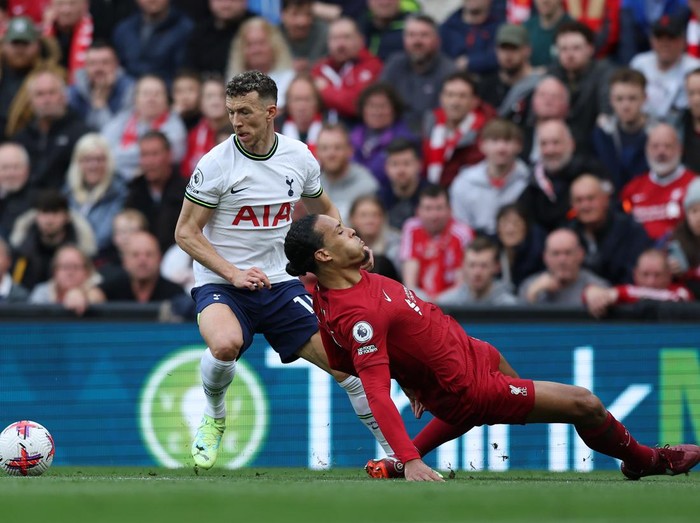 LIVERPOOL, ENGLAND - APRIL 30: Virgil van Dijk of Liverpool slips whilst under pressure from Ivan Perisic of Tottenham Hotspur   during the Premier League match between Liverpool FC and Tottenham Hotspur at Anfield on April 30, 2023 in Liverpool, England. (Photo by Tottenham Hotspur FC/Tottenham Hotspur FC via Getty Images)