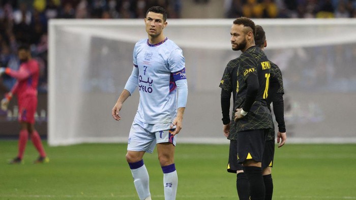 Riyadh All-Stars Portuguese forward Cristiano Ronaldo (C), Paris Saint-Germains Argentine forward Lionel Messi (2nd-R), and Paris Saint-Germains Brazilian forward Neymar (R) are pictured on the pitch during the Riyadh Season Cup football match between the Riyadh All-Stars and Paris Saint-Germain at the King Fahd Stadium in Riyadh on January 19, 2023. (Photo by Giuseppe CACACE / AFP) (Photo by GIUSEPPE CACACE/AFP via Getty Images)