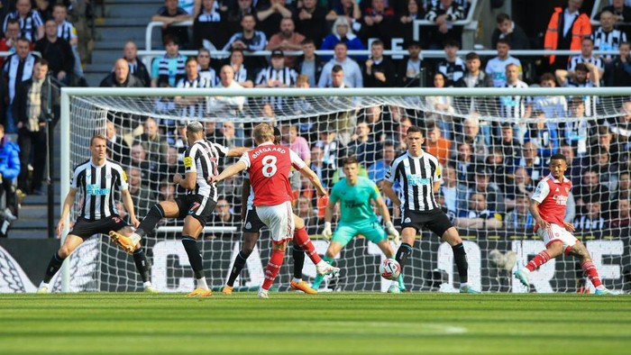 Arsenals Norwegian midfielder Martin Odegaard (C) shoots and scores his teams first goal during the English Premier League football match between Newcastle United and Arsenal at St James Park in Newcastle-upon-Tyne, north east England on May 7, 2023. (Photo by Lindsey Parnaby / AFP) / RESTRICTED TO EDITORIAL USE. No use with unauthorized audio, video, data, fixture lists, club/league logos or live services. Online in-match use limited to 120 images. An additional 40 images may be used in extra time. No video emulation. Social media in-match use limited to 120 images. An additional 40 images may be used in extra time. No use in betting publications, games or single club/league/player publications. /  (Photo by LINDSEY PARNABY/AFP via Getty Images)