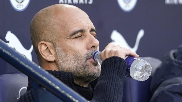 Manchester Citys head coach Pep Guardiola drinks a water ahead the English Premier League soccer match between Manchester City and West Ham United at Etihad stadium in Manchester, England, Wednesday, May 3, 2023. (AP Photo/Dave Thompson)