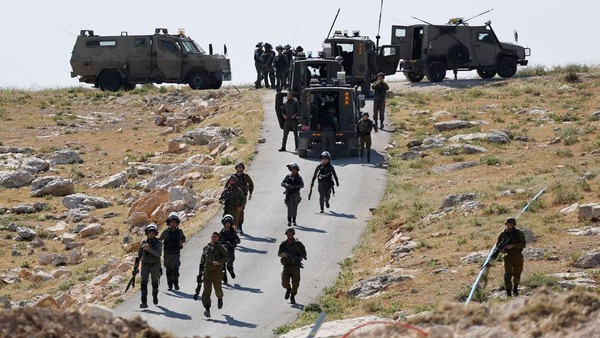 Tentara Israel saat terlibat bentrok dengan warga Palestina saat menghancurkan sebuah sekolah di Tepi Barat Israeli troops take position during clashes between Palestinians and Israeli troops after Israeli machinery demolish a school near Bethlehem in the Israeli-occupied West Bank May 7, 2023. REUTERS/Mussa Qawasma