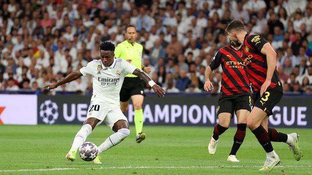 MADRID, SPAIN - MAY 09: Vinicius Junior of Real Madrid scores the team's first goal during the UEFA Champions League semi-final first leg match between Real Madrid and Manchester City FC at Estadio Santiago Bernabeu on May 09, 2023 in Madrid, Spain. (Photo by Julian Finney/Getty Images)