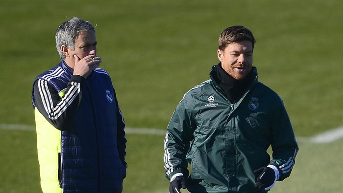 Real Madrids Portuguese coach Jose Mourinho (L) gestures as midfielder Xabi Alonso runs during a training session in Madrid on December 3, 2012 on the eve of the Champions League football match Real Madrid against Ajax Amsterdam. AFP PHOTO/ PIERRE-PHILIPPE MARCOU (Photo credit should read PIERRE-PHILIPPE MARCOU/AFP via Getty Images)