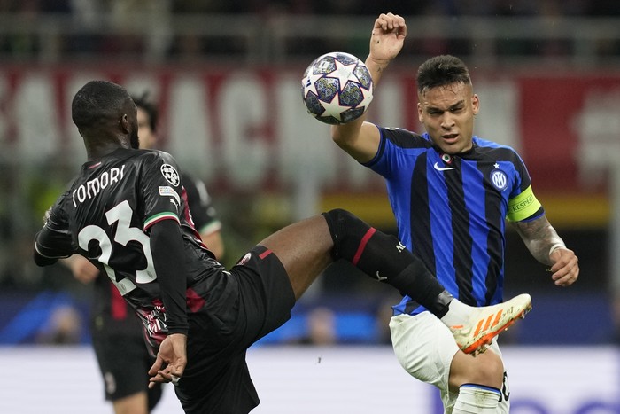 Inter Milans Lautaro Martinez, right, fights for the ball with AC Milans Fikayo Tomori during the Champions League semifinal first leg soccer match between AC Milan and Inter Milan at the San Siro stadium in Milan, Italy, Wednesday, May 10, 2023. (AP Photo/Antonio Calanni)