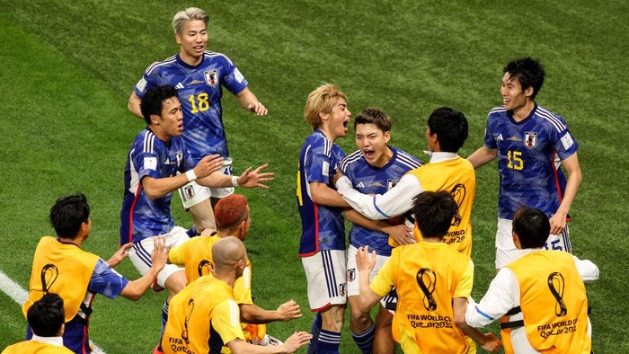 DOHA, QATAR - NOVEMBER 23: Doan Ritsu #8 of Japan celebrates his goal with teammates during the FIFA World Cup Qatar 2022 Group E match between Germany and Japan at Khalifa International Stadium on November 23, 2022 in Doha, Qatar. (Photo by Zhizhao Wu/Getty Images)