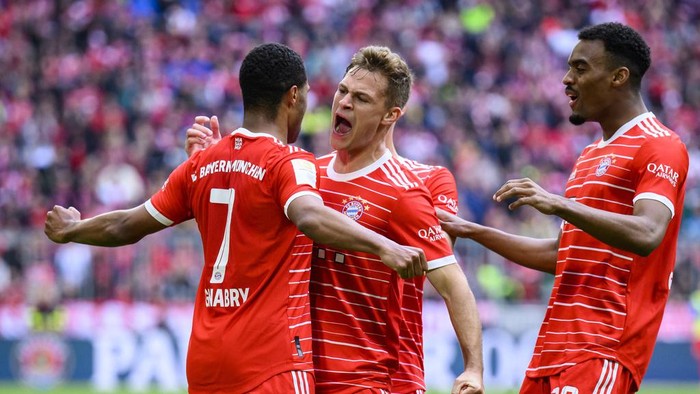 Munichs scorer Serge Gnabry, left, celebrates with his teammates Joshua Kimmich, center, and Ryan Gravenberch, right, celebrate their sides fourth goal during the German Bundesliga soccer match between FC Bayern Munich and FC Schalke 04 in Munich, Germany, Saturday, May 13, 2023. (Tom Weller/dpa via AP)