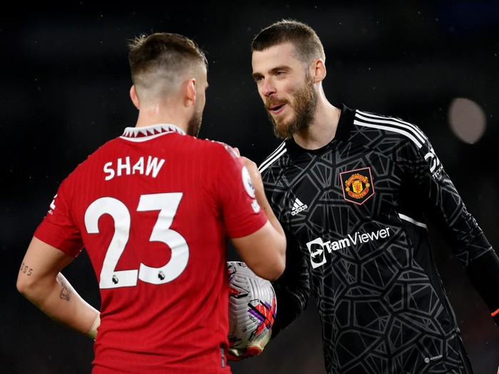 BRIGHTON, ENGLAND - MAY 04: David De Gea of Manchester United interacts with teammate Luke Shaw during the Premier League match between Brighton & Hove Albion and Manchester United at American Express Community Stadium on May 04, 2023 in Brighton, England. (Photo by Mike Hewitt/Getty Images)
