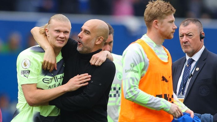 LIVERPOOL, ENGLAND - MAY 14: Josep Pep Guardiola, manager of Manchester City, celebrates with Erling Haaland of Manchester City during the Premier League match between Everton FC and Manchester City at Goodison Park on May 14, 2023 in Liverpool, England. (Photo by James Gill - Danehouse/Getty Images)