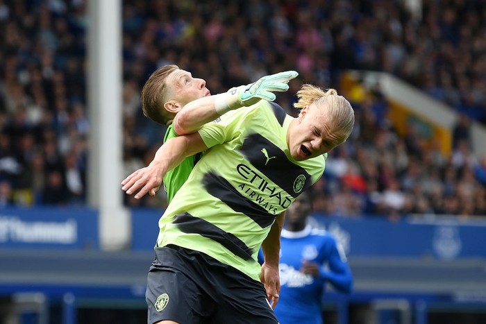 LIVERPOOL, ENGLAND - MAY 14: Jordan Pickford of Everton clashes with Erling Haaland of Manchester City in the box during the Premier League match between Everton FC and Manchester City at Goodison Park on May 14, 2023 in Liverpool, England. (Photo by Michael Regan/Getty Images)