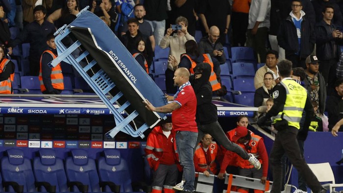 Soccer Football - LaLiga - Espanyol v Barcelona - RCDE Stadium, Cornella de Llobregat, Spain - May 14, 2023
Espanyol fans invade the pitch and pick up a bench after the match REUTERS/Albert Gea