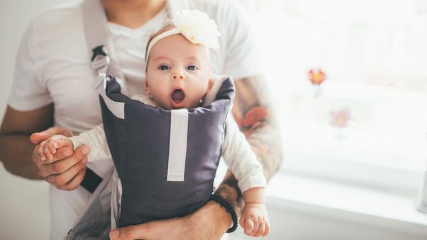 A photo of father playing with his daughter in the morning.