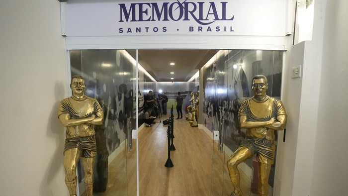 Fans visit the tomb of the late Brazilian soccer great Pele which became open to the public for the first time at the mausoleum of Necropole Ecumenica Memorial Cemetery in Santos, Brazil, Monday, May 15, 2023. (AP Photo/Andre Penner)