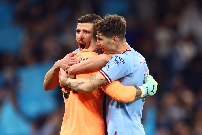 MANCHESTER, ENGLAND - MAY 17: John Stones of Manchester City celebrates with Ederson & Ruben Dias at the end of the UEFA Champions League semi-final second leg match between Manchester City FC and Real Madrid at Etihad Stadium on May 17, 2023 in Manchester, United Kingdom. (Photo by Chris Brunskill/Fantasista/Getty Images)