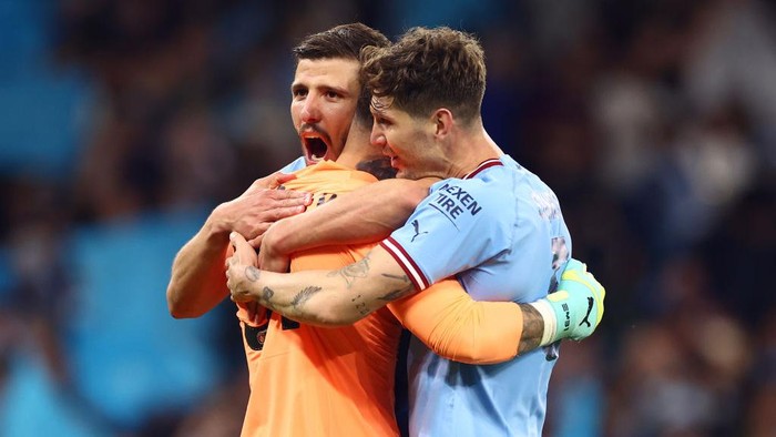 MANCHESTER, ENGLAND - MAY 17:   John Stones of Manchester City celebrates with Ederson & Ruben Dias at the end of the UEFA Champions League semi-final second leg match between Manchester City FC and Real Madrid at Etihad Stadium on May 17, 2023 in Manchester, United Kingdom. (Photo by Chris Brunskill/Fantasista/Getty Images)