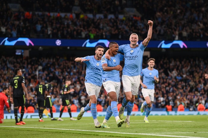 MANCHESTER, ENGLAND - MAY 17: Manuel Akanji celebrates with Erling Haaland of Manchester City after scoring the teams third goal during the UEFA Champions League semi-final second leg match between Manchester City FC and Real Madrid at Etihad Stadium on May 17, 2023 in Manchester, England. (Photo by Michael Regan/Getty Images)
