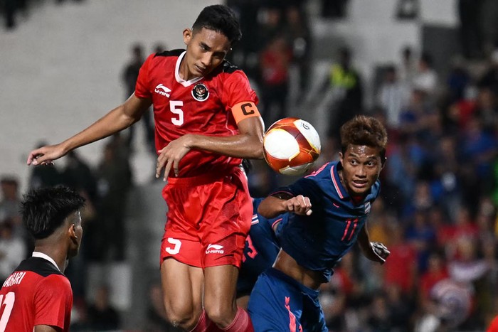 Indonesias Rizky Ridho Ramadhani (C) and Thailands Anan Yodsangwal (R) vie for the ball during the mens football final match at the 32nd Southeast Asian Games (SEA Games) in Phnom Penh on May 16, 2023. (Photo by MOHD RASFAN / AFP) (Photo by MOHD RASFAN/AFP via Getty Images)