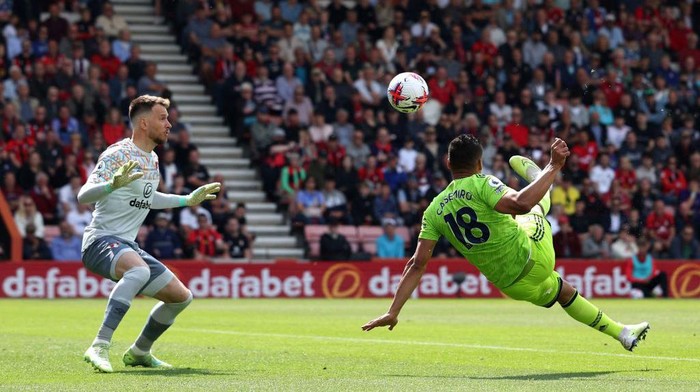 Manchester Uniteds Brazilian midfielder Casemiro (R) scores the opening goal past Bournemouths Brazilian goalkeeper Neto during the English Premier League football match between Bournemouth and Manchester United at the Vitality Stadium in Bournemouth, southern England, on May 20, 2023. (Photo by Adrian DENNIS / AFP) / RESTRICTED TO EDITORIAL USE. No use with unauthorized audio, video, data, fixture lists, club/league logos or live services. Online in-match use limited to 120 images. An additional 40 images may be used in extra time. No video emulation. Social media in-match use limited to 120 images. An additional 40 images may be used in extra time. No use in betting publications, games or single club/league/player publications. /  (Photo by ADRIAN DENNIS/AFP via Getty Images)