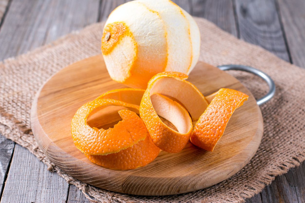 A peeled orange on the wooden background