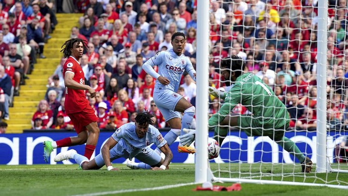 Aston Villas Jacob Ramsey, centre, scores his sides first goal of the game, during the English Premier League soccer match between Liverpool and Aston Villa,  at Anfield stadium, Liverpool, England, Saturday May 20, 2023. (Peter Byrne/PA via AP)