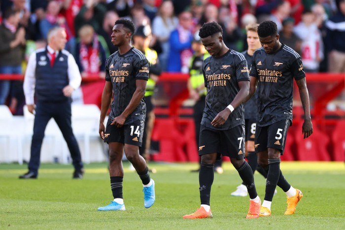 NOTTINGHAM, ENGLAND - MAY 20: Eddie Nketiah, Bukayo Saka and Thomas Partey of Arsenal look dejected after the Premier League match between Nottingham Forest and Arsenal FC at City Ground on May 20, 2023 in Nottingham, England. (Photo by Marc Atkins/Getty Images)