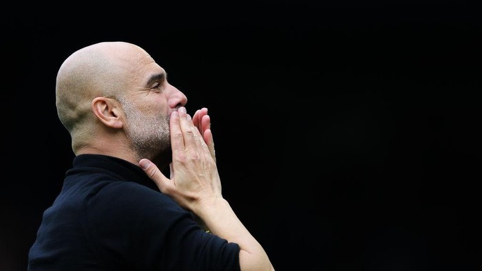 LIVERPOOL, ENGLAND - MAY 14: Josep Pep Guardiola, manager of Manchester City, celebrates with the away support following the Premier League match between Everton FC and Manchester City at Goodison Park on May 14, 2023 in Liverpool, England. (Photo by James Gill - Danehouse/Getty Images)