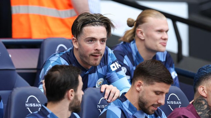 MANCHESTER, ENGLAND - MAY 21: Jack Grealish and Erling Haaland of Manchester City (R) look on from the bench during the Premier League match between Manchester City and Chelsea FC at Etihad Stadium on May 21, 2023 in Manchester, England. (Photo by Michael Regan/Getty Images)