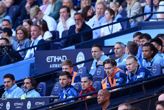 MANCHESTER, ENGLAND - MAY 21: Jack Grealish and Erling Haaland of Manchester City (R) look on from the bench during the Premier League match between Manchester City and Chelsea FC at Etihad Stadium on May 21, 2023 in Manchester, England. (Photo by Michael Regan/Getty Images)